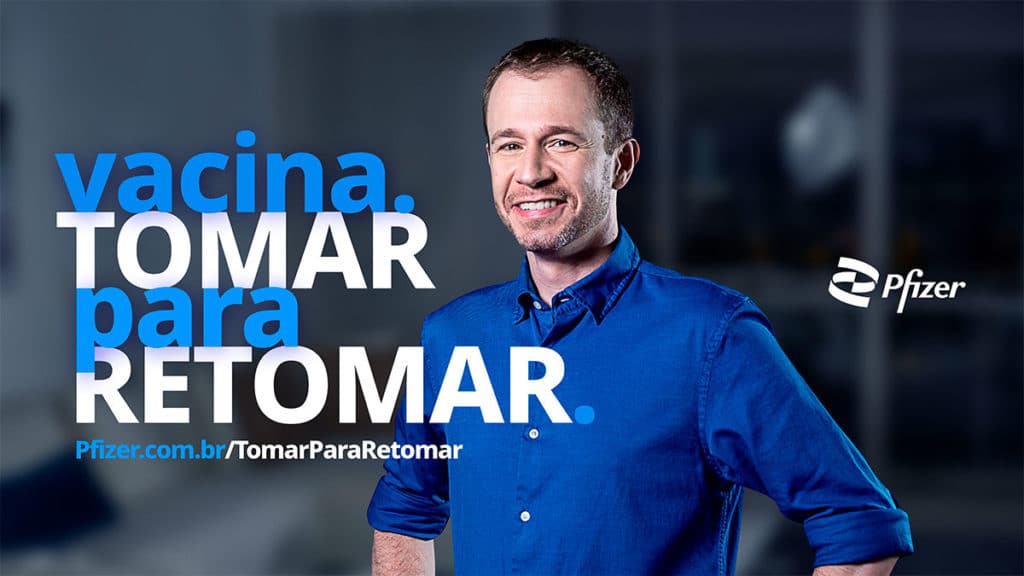 Foto de divulgação da campanha da Pfizer com o Tiago Leifert. A foto apresenta o apresentador e a frase "vacina, tomar para retomar".