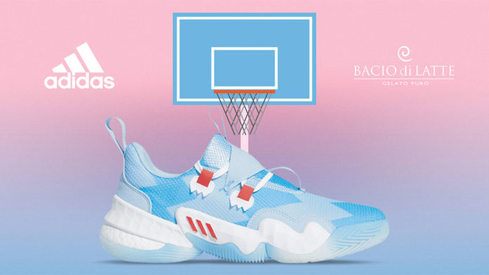A foto apresenta um fundo degradê de azul e rosa, com o tênis a frente junto de uma cesta de basquete, com os logos da Adidas e da Bacio di Latte, uma de cada lado da foto.