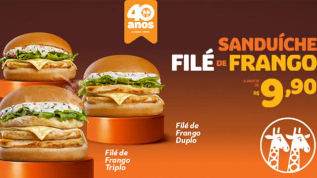 A foto apresenta os novos sanduíches de frango do Giraffas com o logo da rede e o valor de R$ 9,90 ao lado.