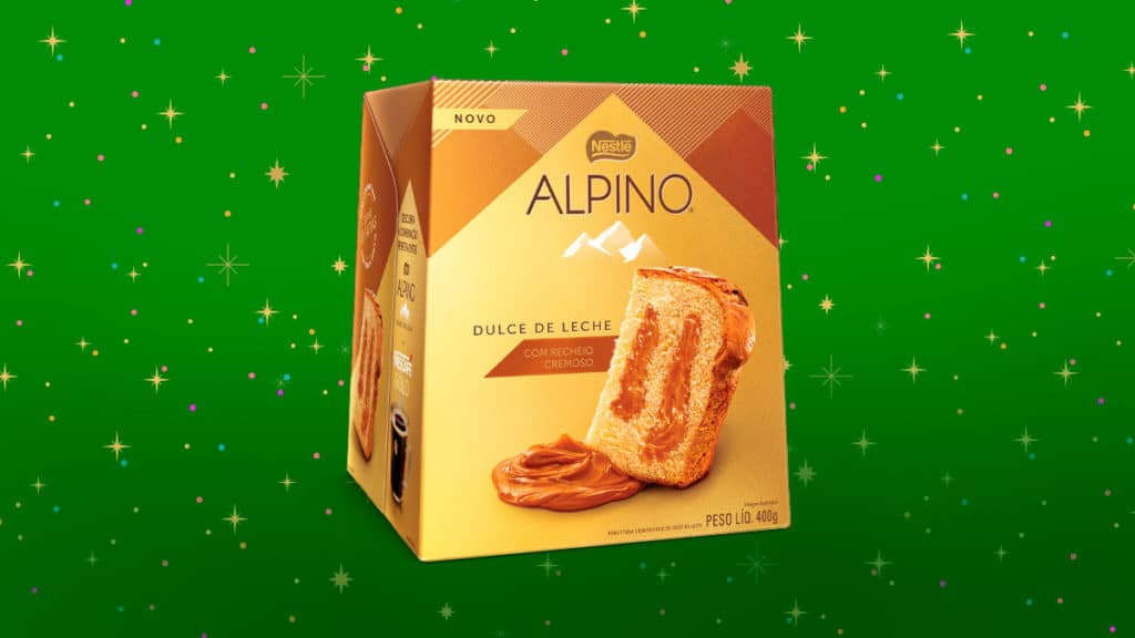A foto apresenta o Panettone de Alpino de Doce de Leite e um fundo verde com estrelas.