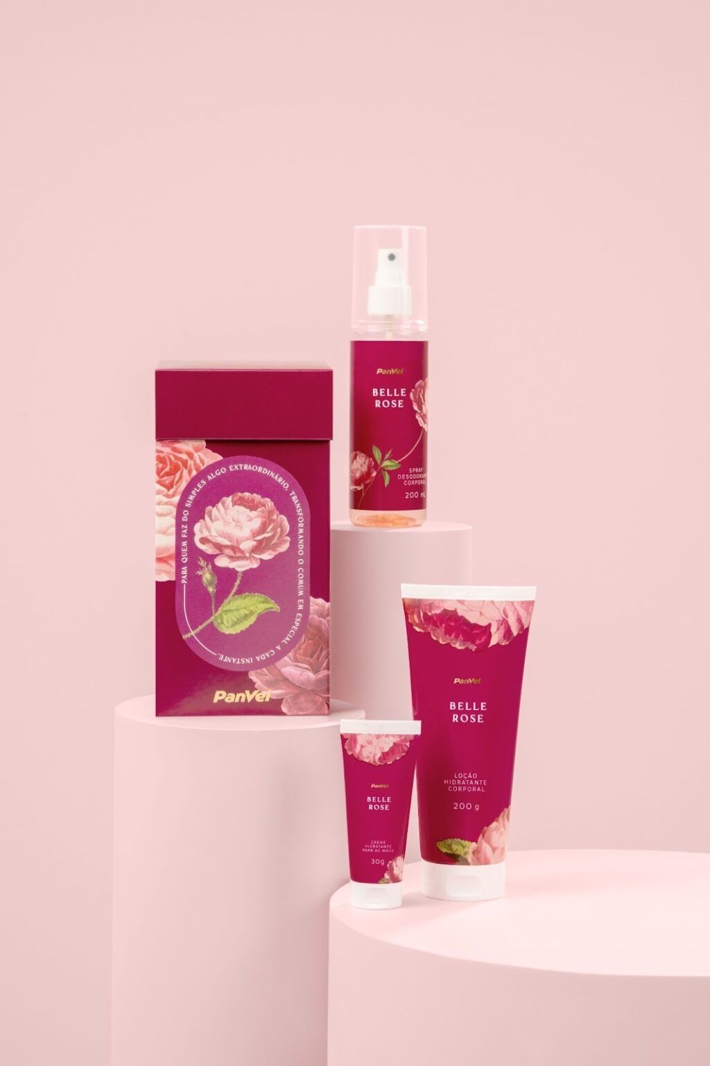 Imagem de produtos da coleção Belle Rose da Panvel, incluindo um creme para as mãos, spray desodorante corporal e loção hidratante, todos com embalagem na cor rosa e detalhes florais.