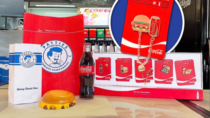 Imagem de um combo de hambúrguer da Patties com batatas fritas, uma garrafa de Coca-Cola e uma embalagem temática da Icebrg contendo pins colecionáveis.