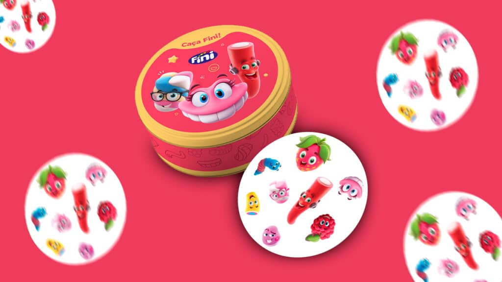 gkpb-banner-fini-jogo-cartas Caixa do jogo de cartas Caça Fini com ilustrações coloridas dos produtos Fini, em um fundo rosa.