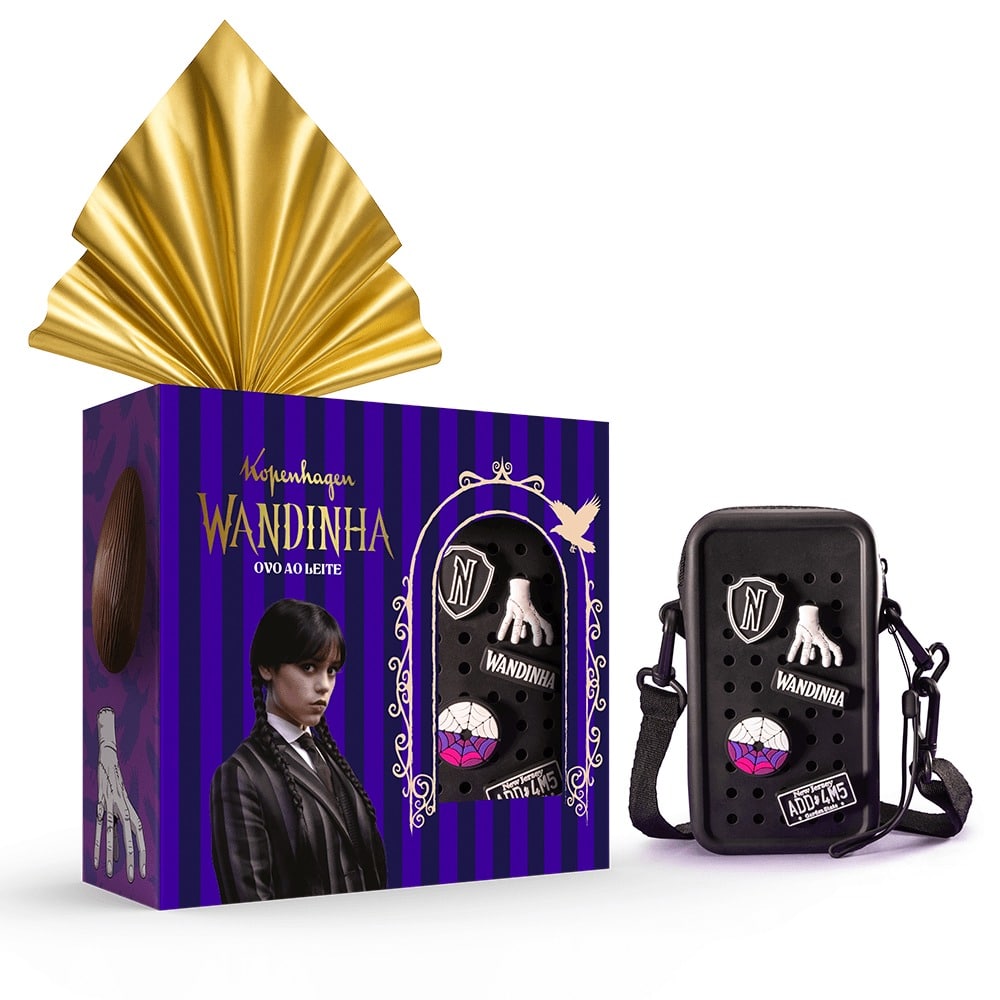 Uma caixa de presente preta com fita dourada, apresentando um personagem de um programa popular, juntamente com uma pequena bolsa preta adornada com desenhos peculiares, incluindo uma mão e uma gema colorida.