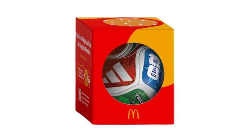 A colorful McDonald's box containing soccer balls, featuring various designs and logos, including FIFA branding.