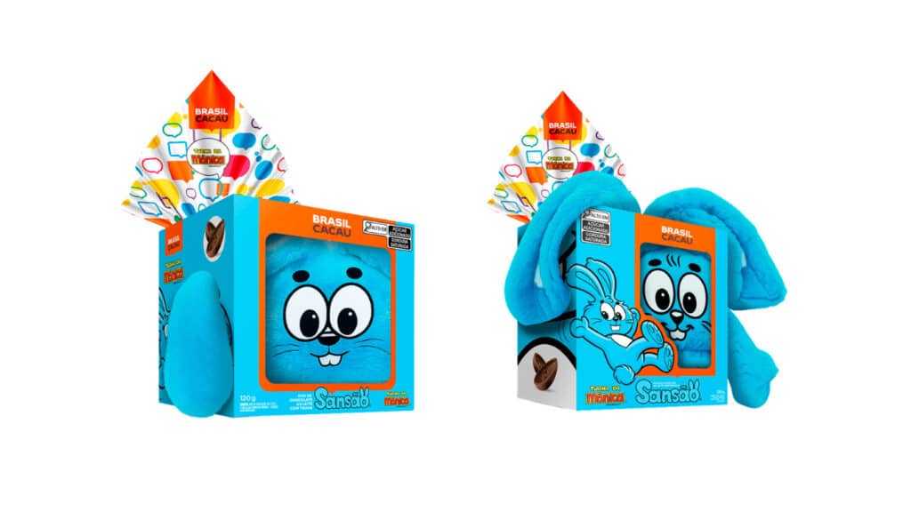 Two blue plush toys shaped like cartoon characters, packaged in colorful boxes with branding, featuring playful designs and illustrations.