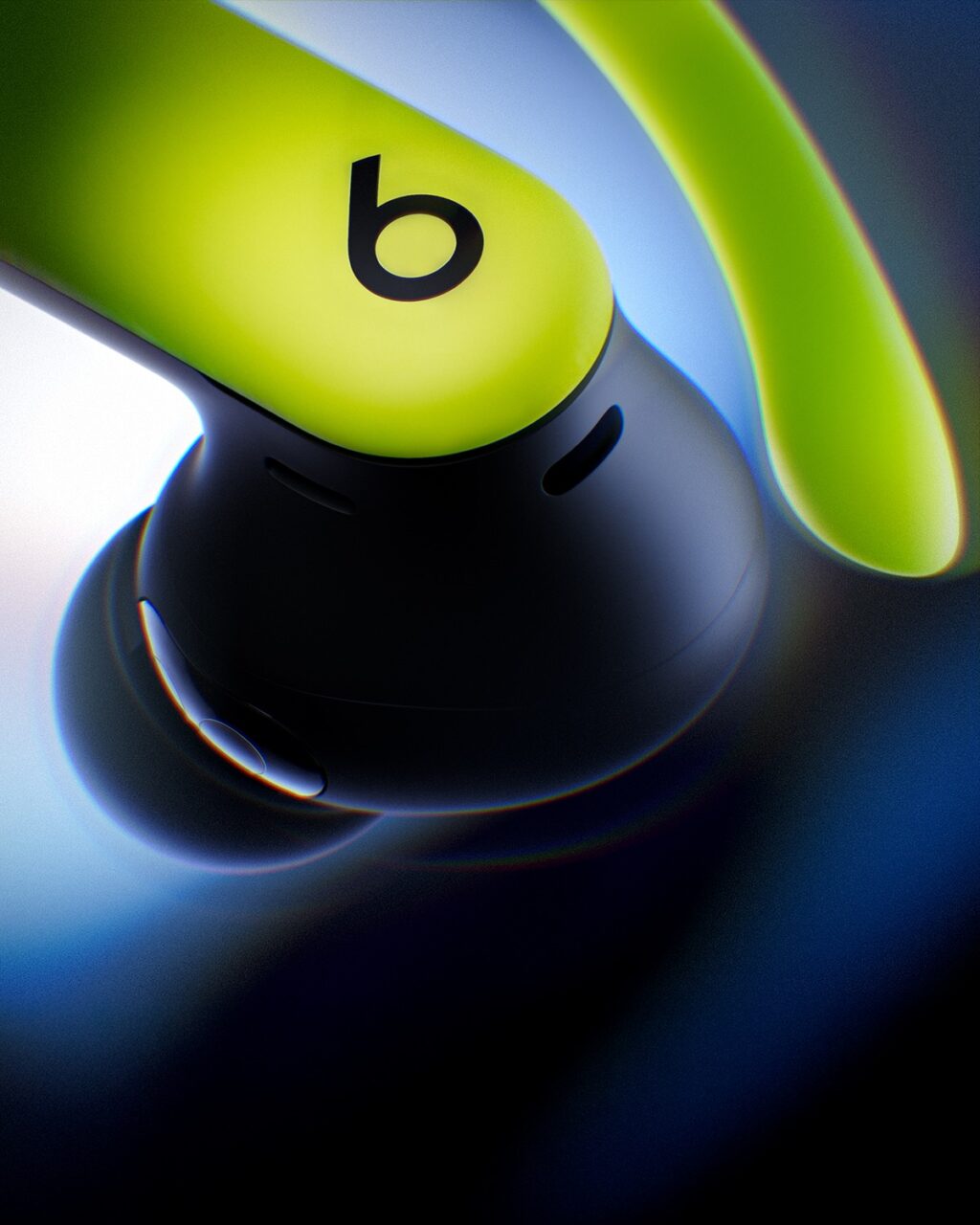 Close-up of a pair of wireless earbuds with a vibrant green and black design, featuring the 'b' logo.