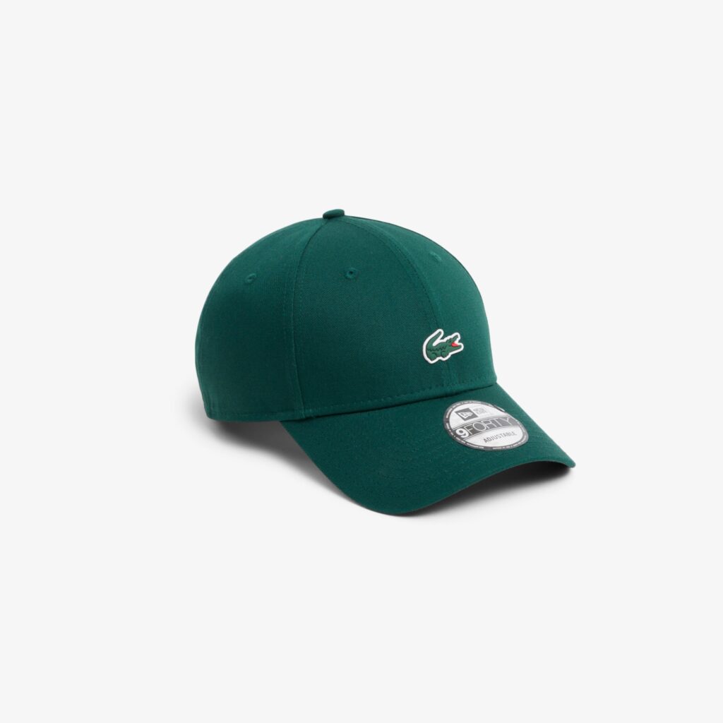 A green baseball cap with a Lacoste logo on the front.