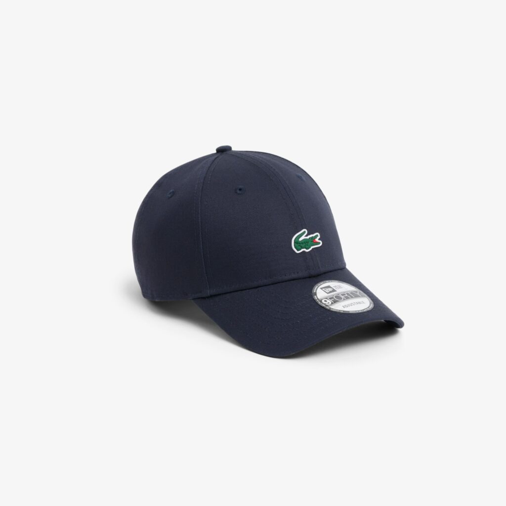 Navy blue baseball cap with a green crocodile logo on the front.