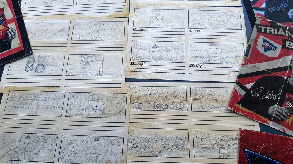 A collection of hand-drawn storyboards and sketches on aged paper, featuring various scenes and characters, along with a Doritos promotional booklet in the corner.