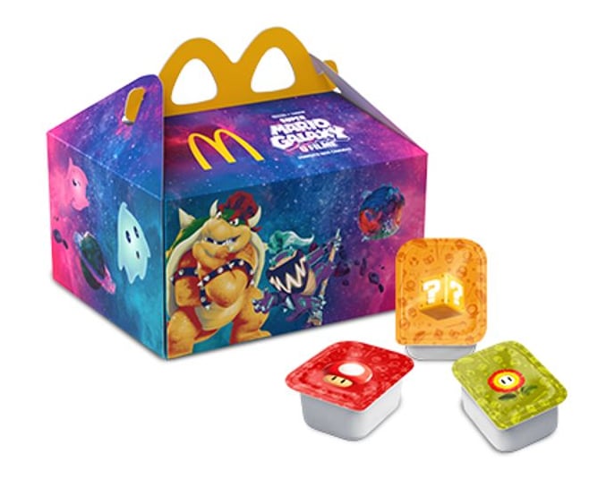Caixa de promoção do McDonald's com tema de Mario, apresentando personagens icônicos como Bowser, acompanhada de molhos coloridos.