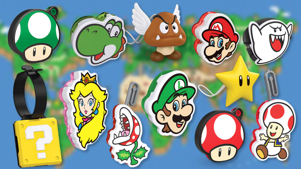 Uma coleção de chaveiros coloridos com personagens e itens icônicos da Nintendo, incluindo Mario, Luigi, Princesa Peach, Yoshi, Toad e um bloco de interrogação, sobre um fundo de mapa.
