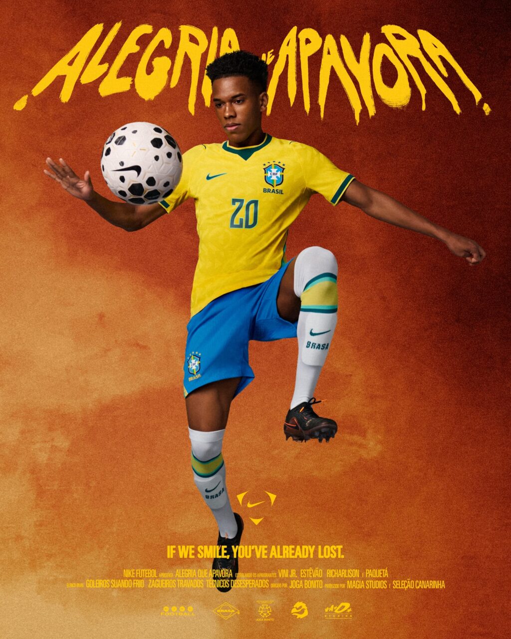 Young male soccer player from Brazil in a yellow and blue uniform, juggling a soccer ball with his right foot, set against a vibrant orange background with the text 'ALEGRIA DE APAVORA' and a slogan about smiling.