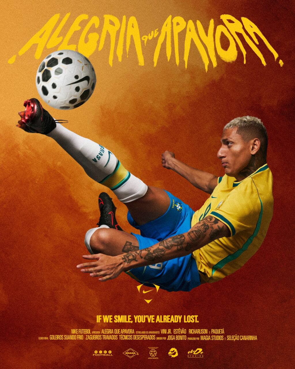 A dynamic soccer player in a yellow jersey performs a kick, while a soccer ball is airborne. The background features warm orange tones and text that reads 'Alegria que Apavora'.