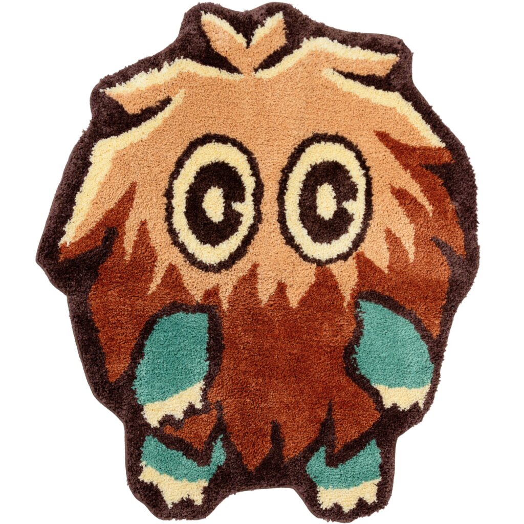 Personagem em patch felpudo estilo Yu-Gi-Oh! com rosto de Marik, tons marrom, amarelo e chamas