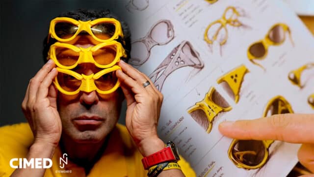 Homem segurando óculos amarelos em estilo do Canarinho, com fundo gráfico do lançamento Cimed e NJR Eyewear.