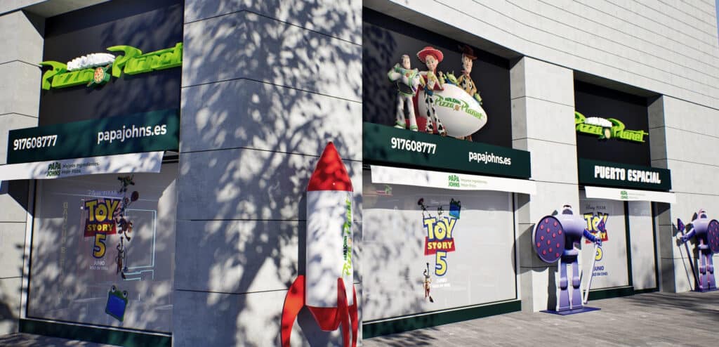 Fachada da Papa Johns em Madrid com decoração do Pizza Planet e pop-ups do Toy Story 5