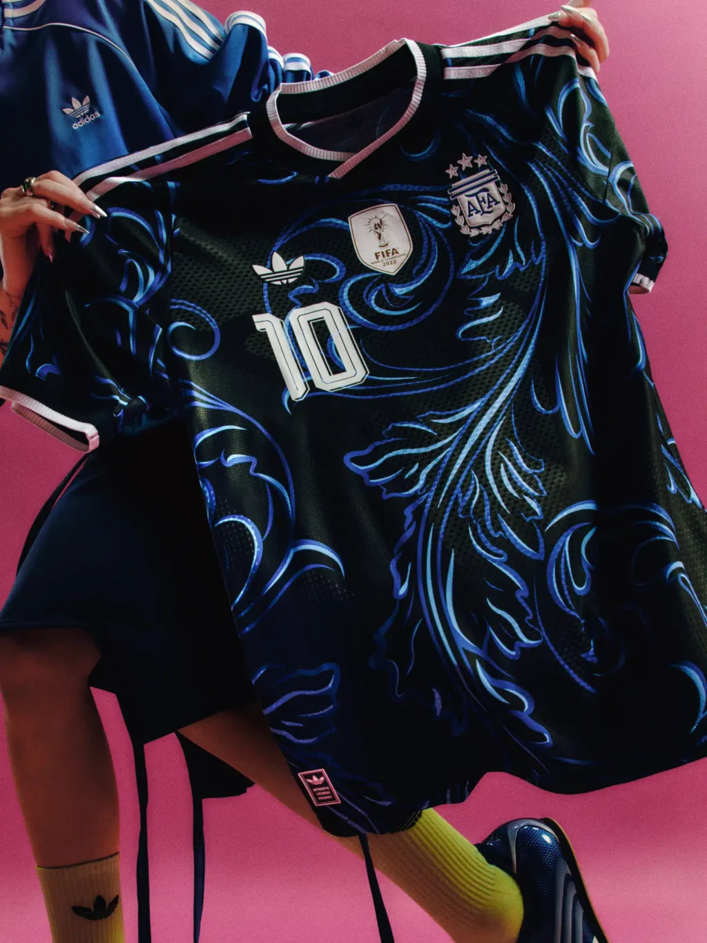 Camisa da Argentina com escudo AFA e emblema FIFA, em fundo rosa, destacando o número 10.