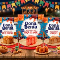 Embalagens de mistura para bolo Dona Benta em cenário de festa junina, com bandeirinhas, decoração colorida e quitutes sobre mesa