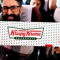 Passageiro segurando caixa de donut Krispy Kreme em voo, em parceria com a LATAM Airlines