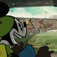 Mickey Mouse, com uniforme verde e preto, acompanha jogo de futebol em estádio e declara torcida pelo Brasil