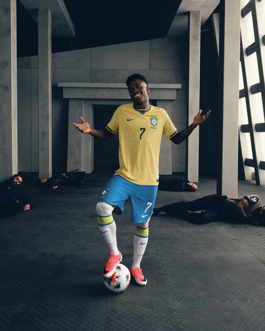 Vini Jr. na camisa da Seleção Brasileira, celebrando com as mãos abertas em campanha da Nike “Rip the Script”