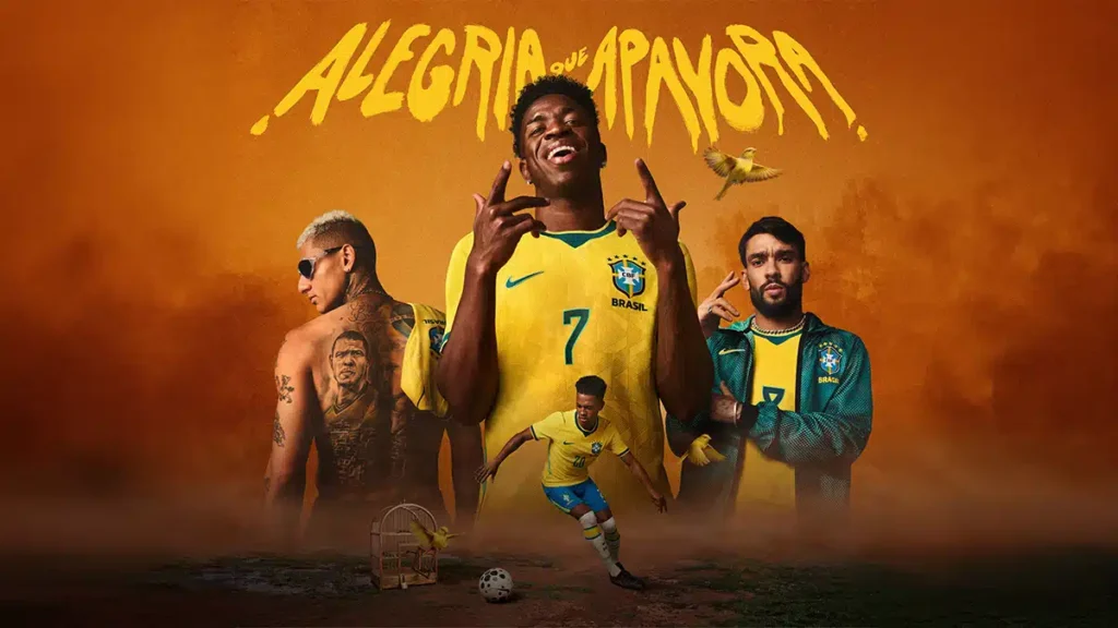 Campanha com jogadores brasileiros em uniforme amarelo e verde, com bola e texto “ALEGRIA QUE APANHORA”.