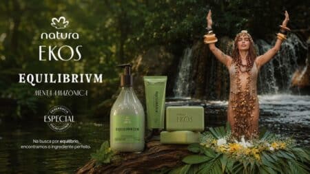 Natura Ekos EQUILIBRIVM com Anitta e produtos de edição limitada Cena promocional da linha Natura Ekos EQUILIBRIVM com frascos e creme ao lado de Anitta em um cenário com água e natureza.