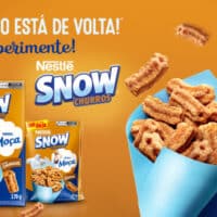 Embalagens e cereal Snow Churros da Nestlé, edição limitada, com churros em destaque sobre fundo laranja e azul.