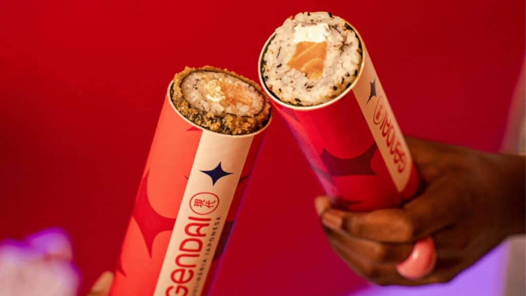 Pessoas seguram cones do Gendai com Push Pop, em vermelho, com recheios no interior do cone.
