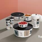 Conjunto de produtos Tupperware com estampas de Mickey e Minnie Mouse, sobre mesa, em fundo rosa.