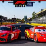 Relâmpago McQueen posicionado na pista como safety car ao lado de carro de Fórmula 1 no GP da Itália.