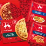Embalagens da Perdigão para Air Fryer, com mini pizzas e empanada, em fundo vermelho com corações.