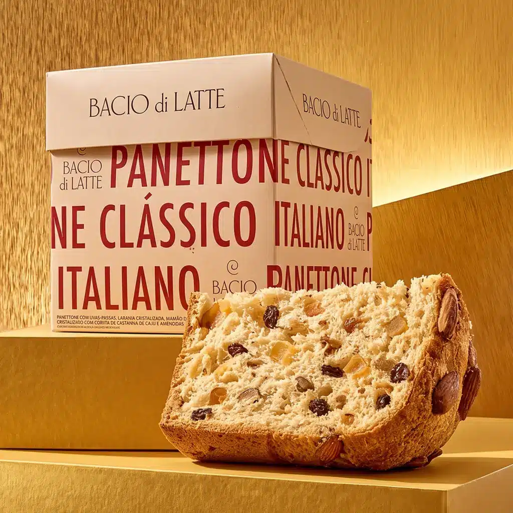 Panettone da Bacio di Latte com pedaço aberto e miolo com gotas de chocolate, embalagem com texto “PANETTONE”