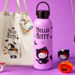 Itens da coleção Hello Kitty Halloween da Todomoda: bolsa, garrafa térmica e acessórios com abóbora e estrelas em fundo roxo