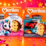 Embalagens de panettones Marilan Unicórnio e Turbo Cars com brinquedos colecionáveis, em cenário de Natal