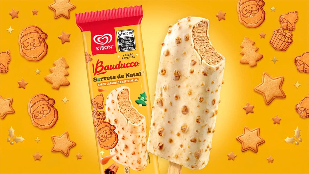 Picolé Natal Bauducco e Kibon com chocolate branco Embalagem e picolé de sorvete Bauducco da Kibon para o Natal, com chocolate branco e biscoito, em fundo temático natalino.