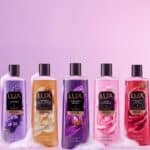 Linha de sabonetes líquidos LUX com diferentes fragrâncias em embalagens repaginadas, em fundo rosa e branco.